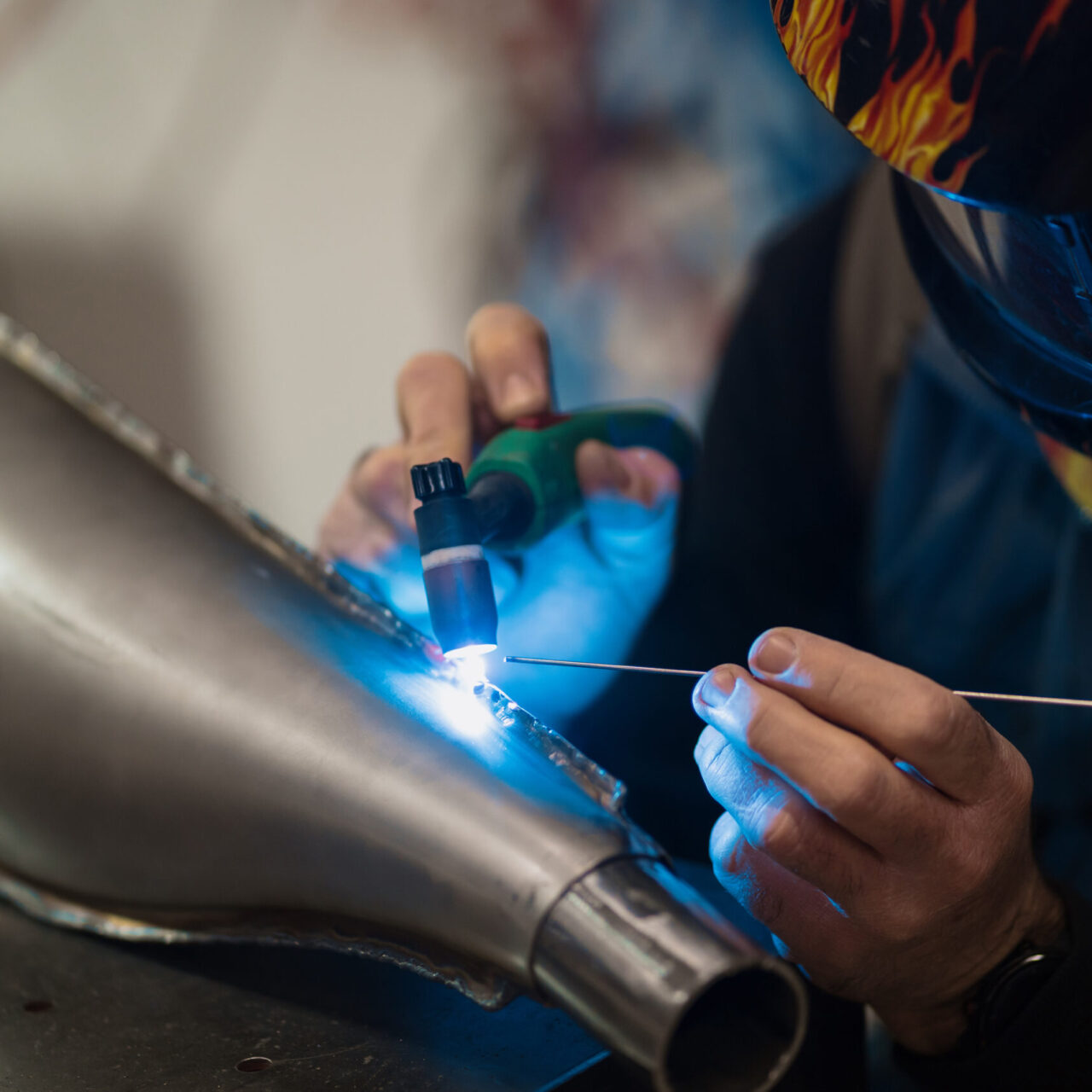 Repairman repair motorcycle, maintenance in garage. Mechanic fixing bike in a modern shop